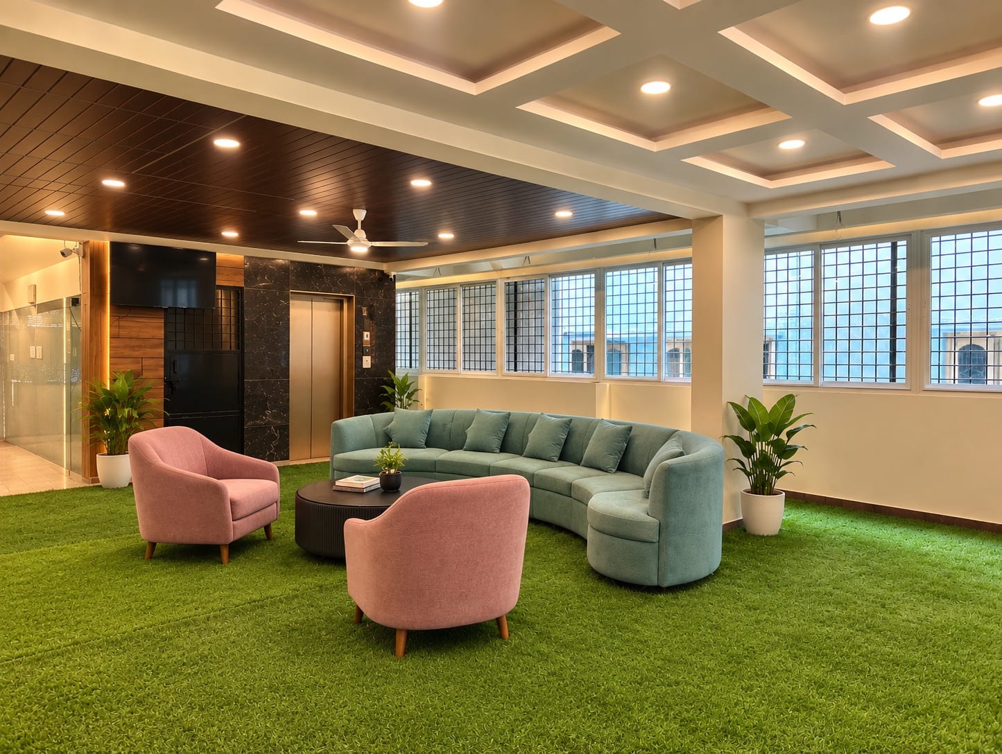 The lounge at Infinity Space PG near Christ University Yeshwanthpur Campus, Bengaluru — a curved sofa and armchairs on turf flooring under a coffered ceiling